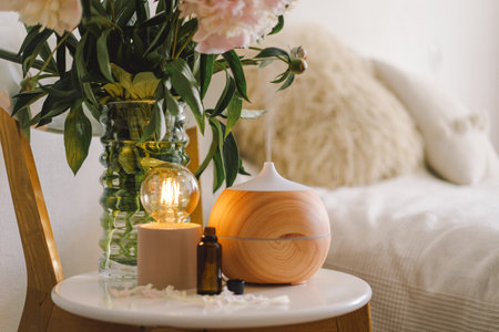 Aroma oil diffuser on chair against in the bedroom. Air freshener.の写真素材