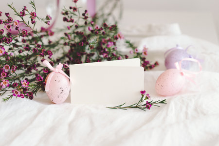 Easter eggs with flowers on white linen fabric.の写真素材