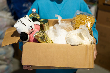 Volunteer girl preparing donation boxes for people.の写真素材