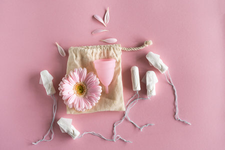 Tampons and menstrual cup on pink background.の写真素材