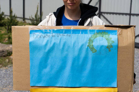 Volunteer teengirl preparing donation boxes for people in need in Ukraine.の写真素材