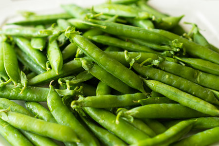 Fresh green peas on a wooden background.