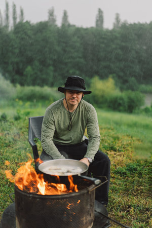 Portrait of a man enjoy the tea by the fire in rainy weather.の写真素材