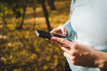 Beautiful girl uses phone for fitness or yoga.の写真素材