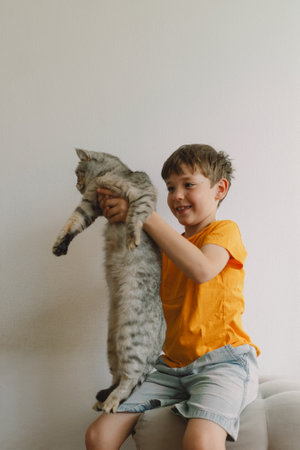 A cute boy hugs his cat. Children and pets. Concept of animals, friendshipの写真素材