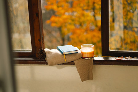 Sweater, candle and autumn decor. Autumn home decor.の写真素材