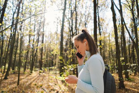 Beautiful girl uses phone for fitness or yoga.の写真素材