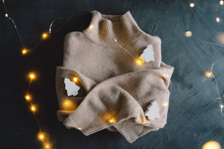 Sweater on a gray background. Warm jumper, stylish autumn or winter clothes