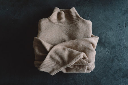 Sweater on a gray background. Warm jumper, stylish autumn or winter clothesの写真素材