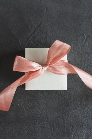 Top view white gift box, adorned with vibrant pink ribbonの写真素材