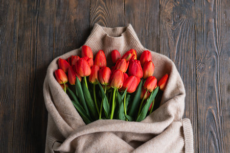 Fresh orange tulips on a wooden background. Springtime.の写真素材