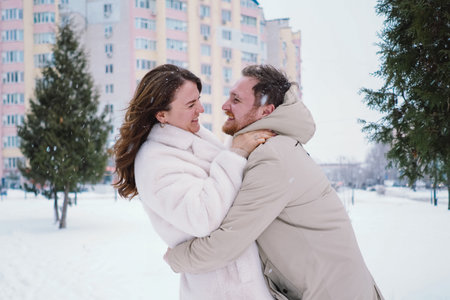 Loving couple on a snowy winter field. Happy together.の写真素材