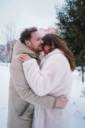 Loving couple on a snowy winter field. Happy together.の写真素材