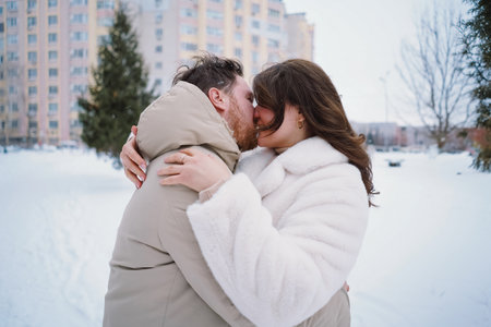 Loving couple on a snowy winter field. Happy together.の写真素材