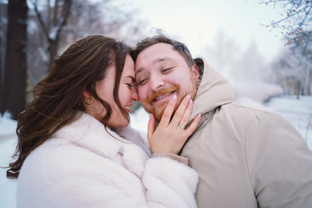 Loving couple on a snowy winter field. Happy together.の写真素材