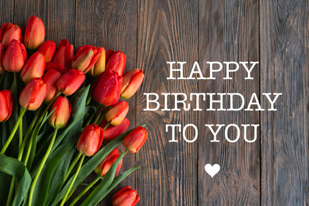 Happy Birthday to you. Bouquet of beautiful fresh orange tulipsの写真素材