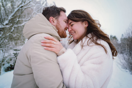 Loving couple on a snowy winter field. Happy together.の写真素材
