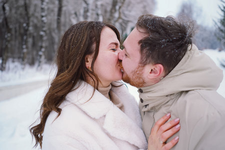 Loving couple on a snowy winter field. Happy together.の写真素材