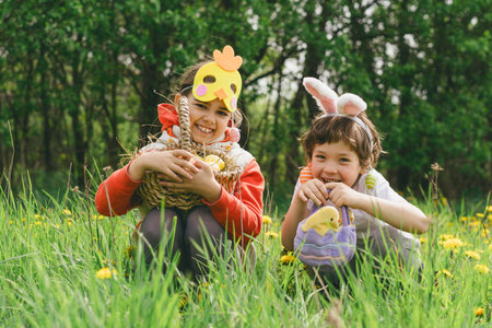 Two children hunt for Easter eggs in a spring garden. Easter traditionの写真素材