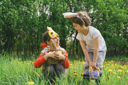 Two children hunt for Easter eggs in a spring garden. Easter traditionの写真素材