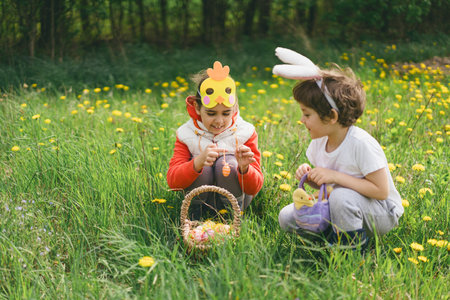 Two children hunt for Easter eggs in a spring garden. Easter tradition