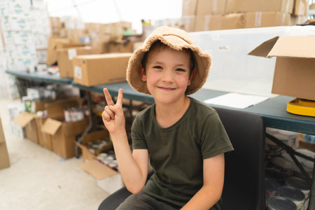 Portrait of a boy in green T-shirt. Humanitarian aid concept.の写真素材
