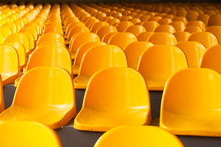 Plenty of yellow plastic seats at stadium.の写真素材