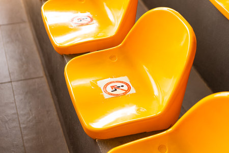 Plenty of yellow plastic seats at stadium.の写真素材