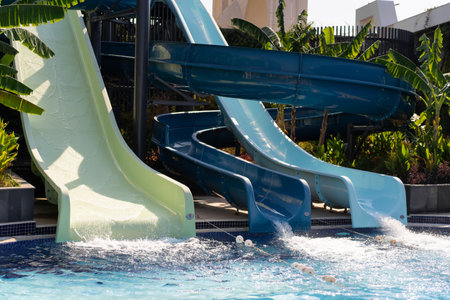 Blue swimming pool with water slideの写真素材