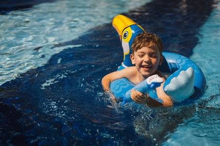 A boy in a swimming pool on a sunny dayの写真素材