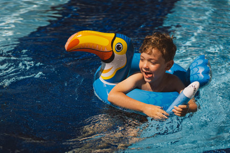 A boy in a swimming pool on a sunny dayの写真素材