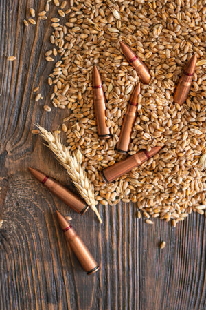 Scattered Wheat Grains and Bullet Shells on a Wooden Surface