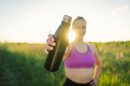 Beautiful girl doing fitness or yoga in nature on a sunny summer sunset.