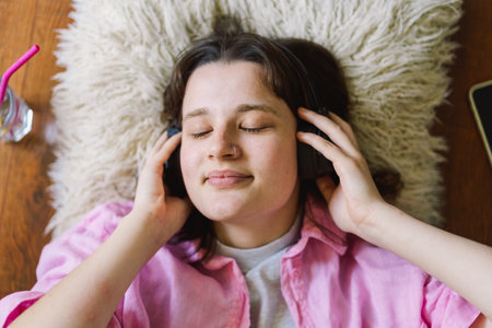 Teengirl Relaxing and listens to music in headphones