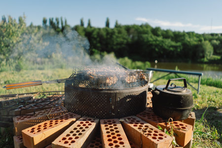 Summer Barbecue With Smoke and Kettle by a River