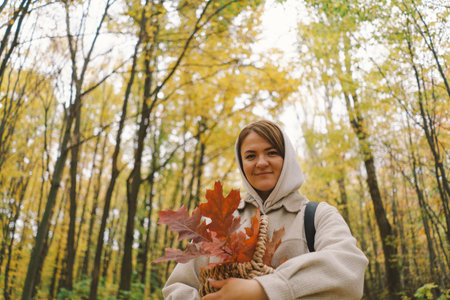 Woman Enjoying Autumn Walk in Forestの写真素材