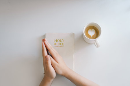 A Christian reads the Bible and drinks coffee. Religion concept.の写真素材