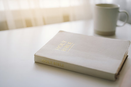 A person reads the Bible and drinks coffee.