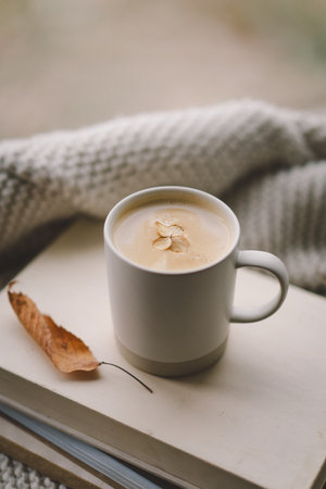 A cozy moment with a warm cup of coffee on a stack of books