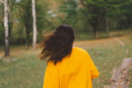 A woman enjoys a sunny day outdoorsの写真素材