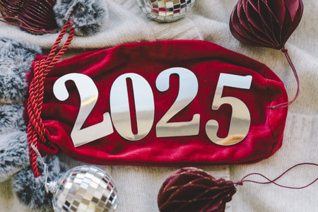 Cozy winter setup with a warm drink, festive decorations, and New Year's numbers.の写真素材