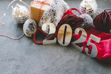 Cozy winter setup with a warm drink, festive decorations, and New Year numbers.の写真素材