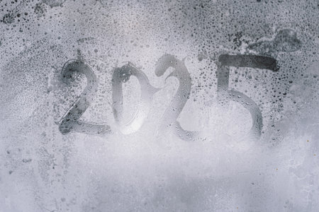 A misty window displaying the year 2025の写真素材