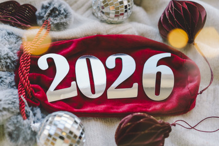 Cozy winter setup with a warm drink, festive decorations, and New Year numbers.