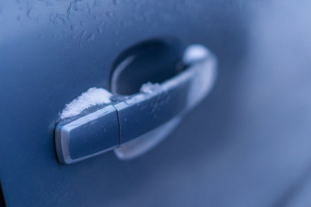 Snow covers the car door handleの写真素材
