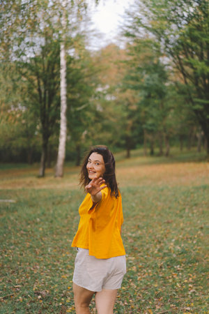 A woman enjoys a sunny day outdoorsの写真素材