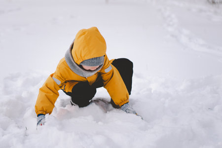 A joyful child playing in fresh snow during winters frosty embraceの写真素材