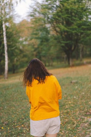 A woman enjoys a sunny day outdoorsの写真素材