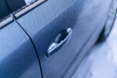 Snow covers the car door handleの写真素材