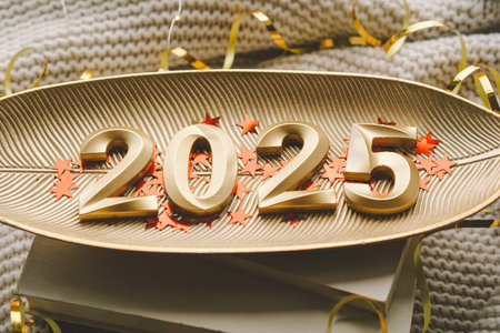 New Year celebration with golden 2025 numerals adorned with festive decorations and sparkling starsの写真素材